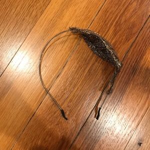 Black headband with moldable silver feather.